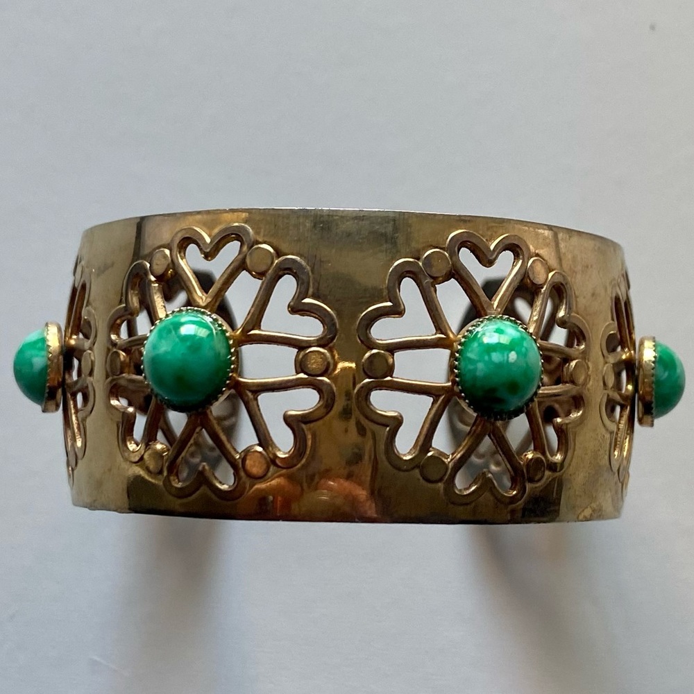 Gold tone bangle bracelet with green stones